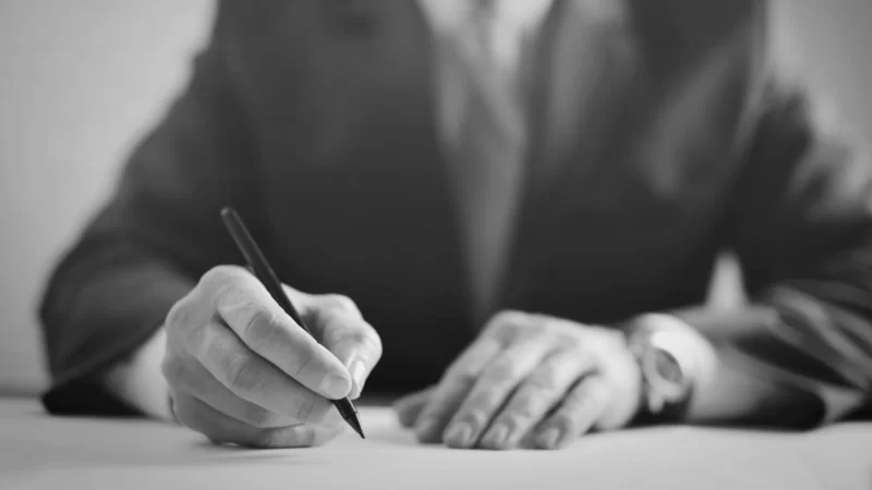 Man signs a piece of paper to confirm Major Changes to EPCs.