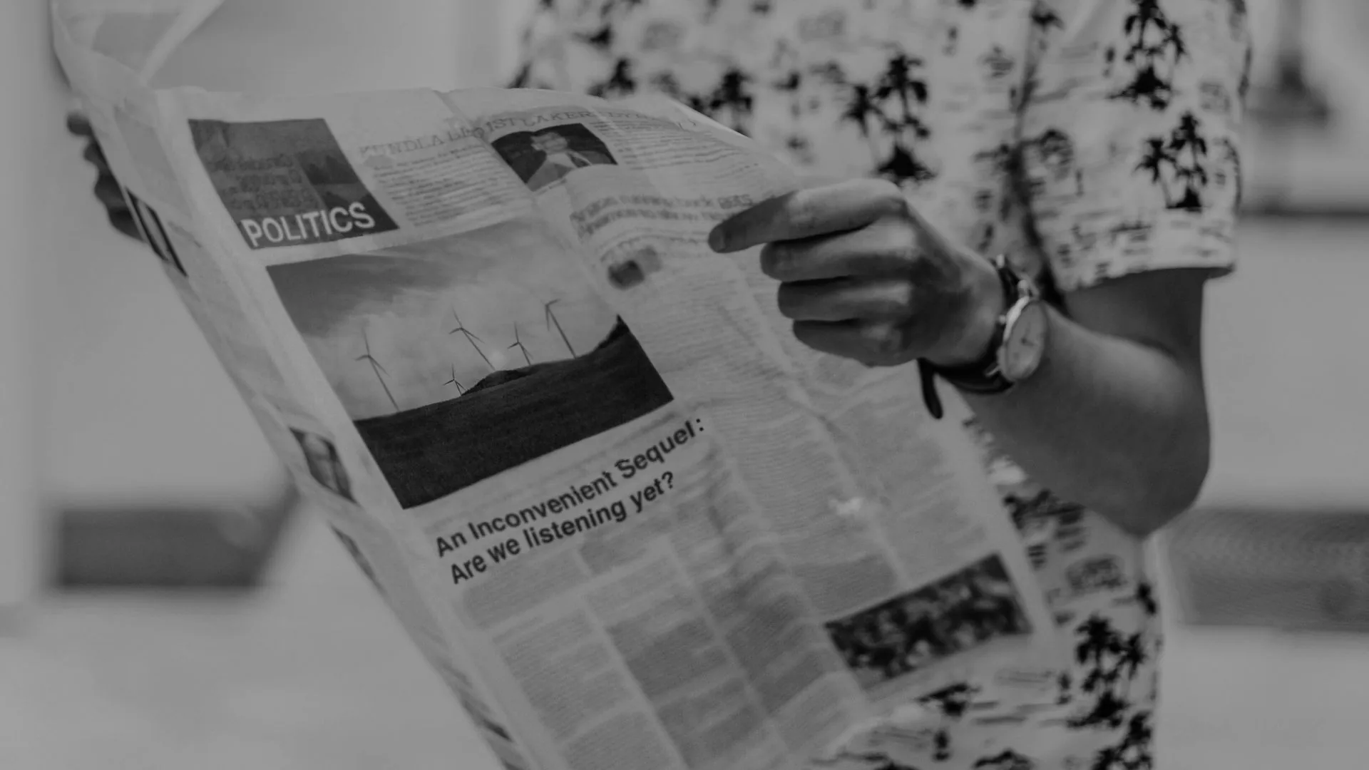 Energy policies discussed in a newspaper being read by a man