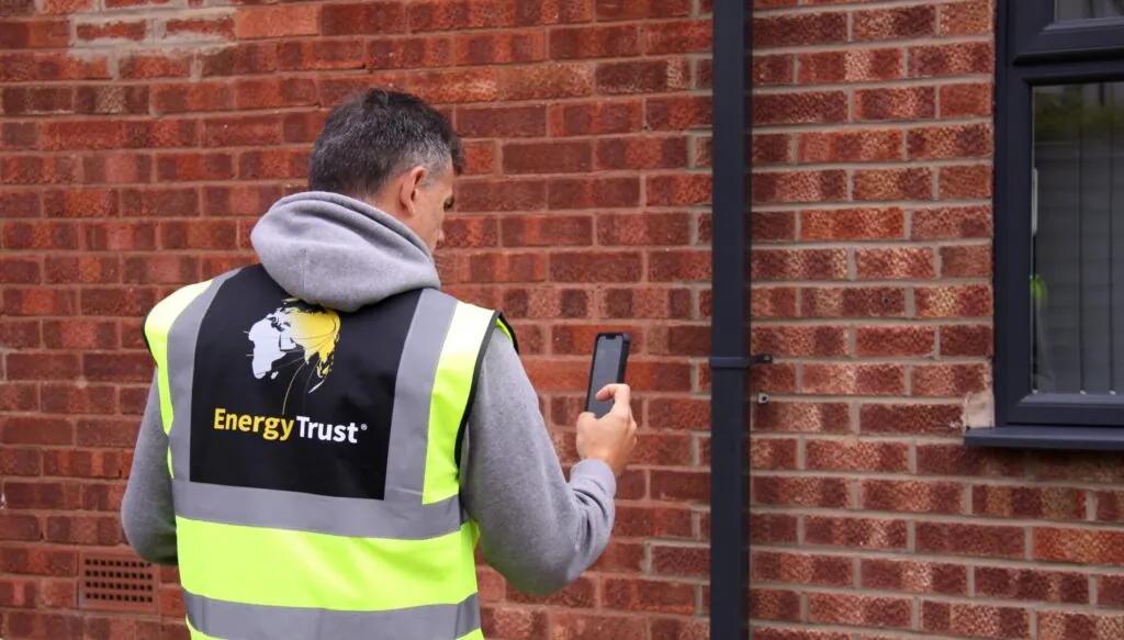 Domestic Energy Assessor taking pictures of the wall construction of a house