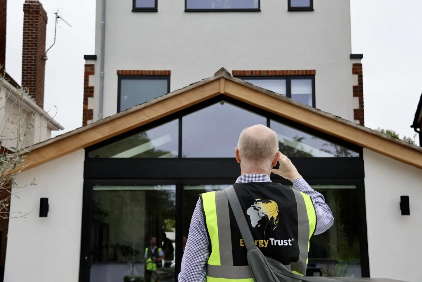 EPC assessor taking photo of property as part of a domestic energy assessment