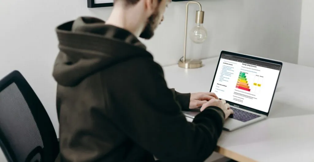 Man looking at Energy Performance Certificate on laptop